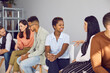 canvas print picture - Diverse group of people sitting in row and talking in pairs. Happy international students practicing conversations in English. Team of corporate clients discussing something at business training