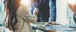 © Natee Meepian - business people handshake at meeting table in office together with confident. Young businessman and businesswoman workers express agreement of investment deal