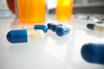 Wall Mural - Medical pills capsules with granules on table closeup