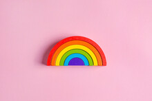 Colorful Waldorf Wooden Rainbow In A Montessori Teaching Pedagogy On Pink Background, Kid Play Concept