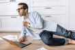 © shunevich - Concentrated businessman lays on floor at home, using laptop, developing new project. Thoughtful stylish male employee or student is working or studying remotely, learning financial graphs