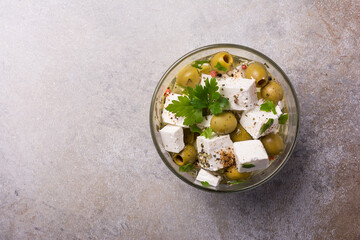 Wall Mural - Bowl of delicious olives with Feta cheese in oil