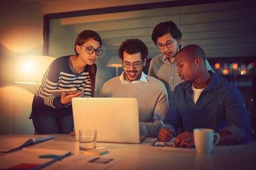Poster - Reaching for all the success they can get. Shot of a group of designers working late in an office.