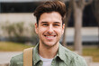 © Jose Calsina - Caucasian happy male in university campus. Portrait of teenage male student standing in a college