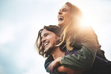 live, laugh, love. shot of a happy young couple having fun outside.