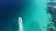 Aerial View Of A Boat Sailing In Turquoise Water
