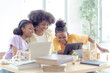 © Sommart Sopon - African American families teaching online learning and education are very warm, everyone is very eager to learn. Make today's classes go smoothly..
