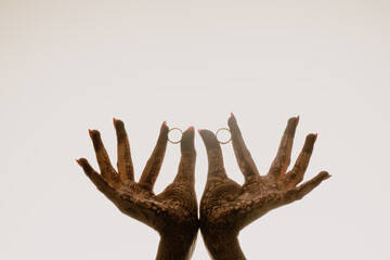 Photo of hands with engagement rings