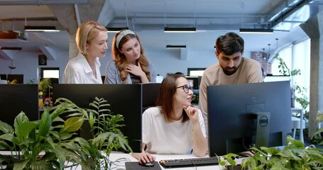 Office workers talking at computer and watching at screen. Male ad females colleagues discussing ideas and solutions for startup. Support team. Programming job. Discussion. Man and women speaking.