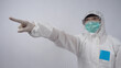 Doctor in PPE suit wearing white medical rubber gloves and clear goggles and green N95 face mask to protect pandemic Coronavirus. gesture make hand sign. Represent victory win over virus. Isolated