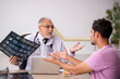 © Elnur - Young male patient visiting old male doctor radiologist