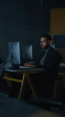 Vertical Screen: Male Student Sitting Alone in College Informatics Room, Working Late Evenings on Computer Science Project. Young Scholar Study IT on Computer in University, Writing Code in Class.