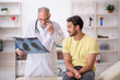 © Elnur - Young male doctor visiting old male doctor radiologist