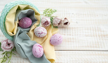 Easter Eggs On Wooden Background. Easter Eggs And Flowers.