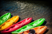 Closeup Of The Colorful Kayaking Boats On The Shore.