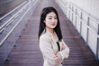 © Eva - confident beautiful chinese business woman with arms crossed standing on runway. Entrepreneur