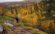 © Andrey - A young woman with a backpack and trekking poles in the Khibiny mountains. The concept of a healthy and active lifestyle. Girl on the background of nature mountains.