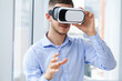 © Maksymiv Iurii - Shot of a young businessman wearing a VR headset in an office