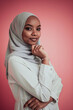 © .shock - Portrait of young modern muslim afro beauty wearing traditional islamic clothes on plastic pink background. Selective focus