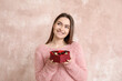 © Pixel-Shot - Happy young woman with delicious chocolate candies in box on color background