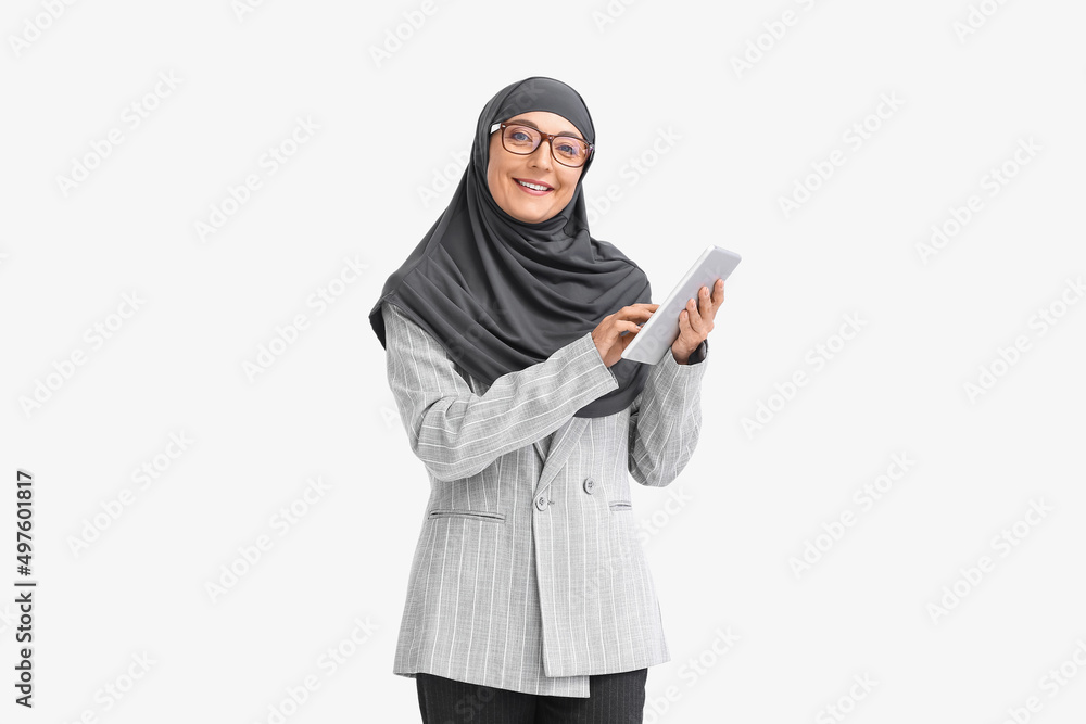 Muslim secretary with tablet on light background