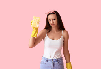 Wall Mural - Sad young woman with sponge on color background