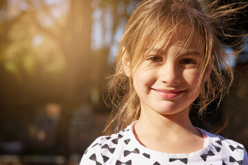 nothing but carefree days. portrait of a little girl enjoying some time outdoors.
