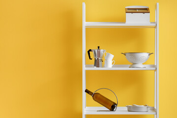 Wall Mural - Modern shelving unit with dishware near yellow wall in kitchen