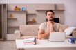 © Elnur - Young male employee working from house