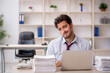 © Elnur - Young male employee and too much work in the office