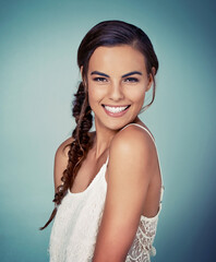 Poster - I definitely had fun making this hairdo. Studio shot of a beautiful young woman posing against a green background.