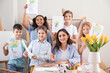 © Pixel-Shot - Cute children and teacher with painted pictures during master-class in art