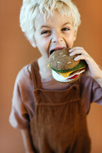 Kid Posing To Take A Bite Of A Felt Wool Burger Toy