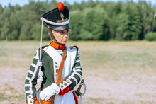 A Woman Soldier Holds A Flute In Her Hands