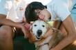 © Erin Brant/Stocksy - Teen boy hugging senior golden retriever