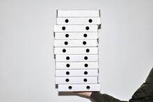 Holding Stack Of Pizza Boxes
