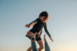 © Erin Brant/Stocksy - Young girl high above father's arms