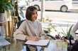 © Igor Kardasov/Stocksy - Attentive female sexologist taking notes during session