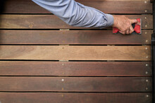Hand Sanding A Timber Deck