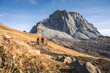 © plpictures by Paedii Luchs/Stocksy - Two people jogging towards the mountains.