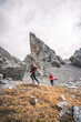 © plpictures by Paedii Luchs/Stocksy - Active couple running in front of pointy mountain peak.