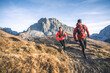 © plpictures by Paedii Luchs/Stocksy - Smiling trail runners in alpine landscape