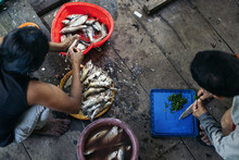 Ethnic Couple Cleaning Fish