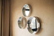 © Malquerida Studio/Stocksy - Three round mirrors on the wall