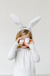 © Sergey Narevskih/Stocksy - Child covering eyes with Easter eggs