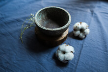 Ceramic Bowl And Dried Flowers On Blue Cloth