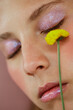 © Ángela Rober/Stocksy - close-up of a young woman with make-up in soft colors