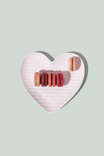 Pastel Pink French Macaron And White Heart Shaped Plate