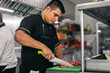 © Pedro Merino/Stocksy - Hispanics chefs working in a restaurant kitchen