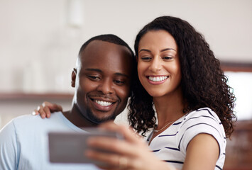 Canvas Print - First selfie of the weekend. Cropped shot of a young married couple taking a selfie in the kitchen at home.